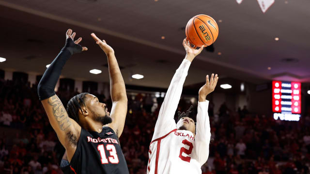 Mar 2, 2024; Norman, Oklahoma, USA; Oklahoma Sooners guard Javian McCollum (2) shoots beside Houston Cougars forward J'Wan Roberts (13) during the second half at Lloyd Noble Center. Mandatory Credit: Alonzo Adams-USA TODAY Sports